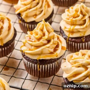 Salted Caramel Mocha Cupcakes 5 Chocolate espresso cupcakes topped with caramel buttercream on cooling rack.