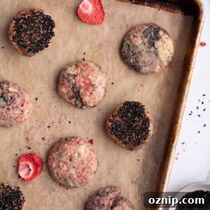 Strawberry black sesame cookies on a baking sheet