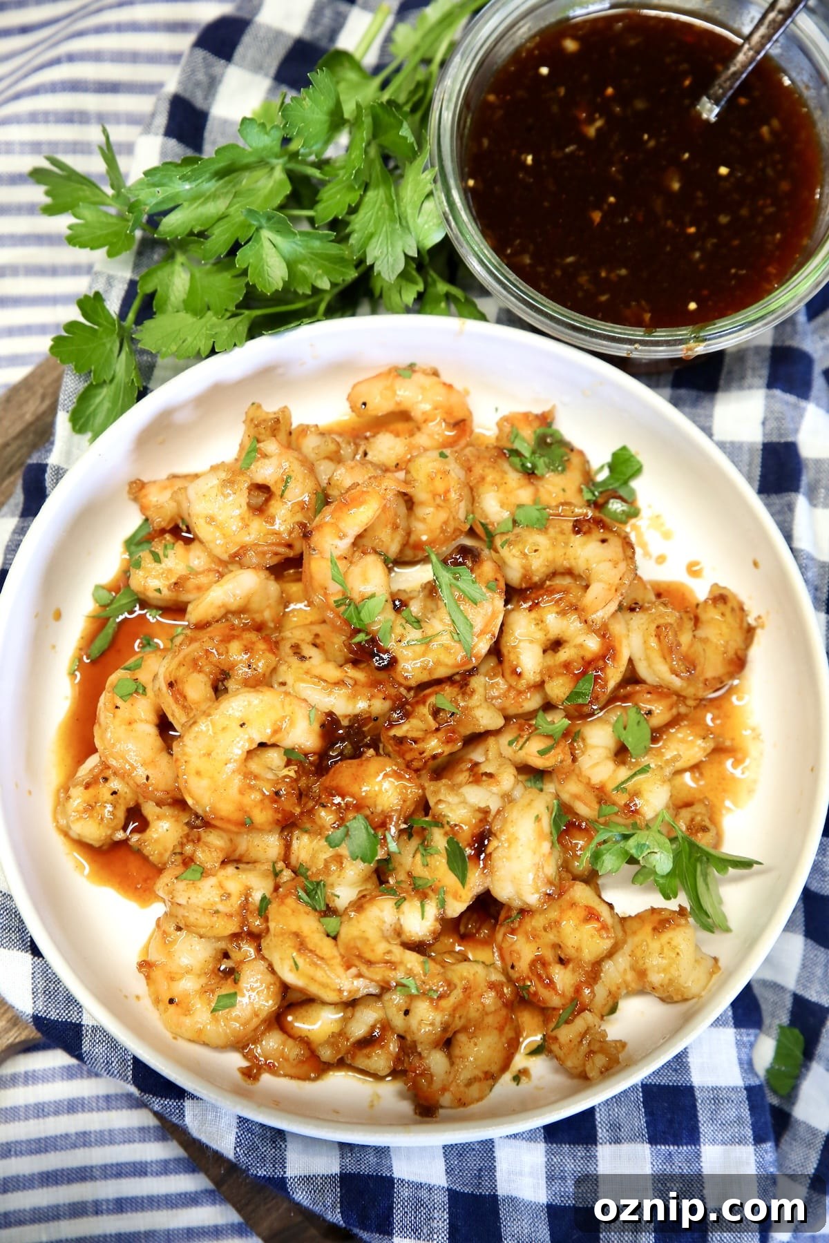 Bowl of shrimp with bowl of sauce.