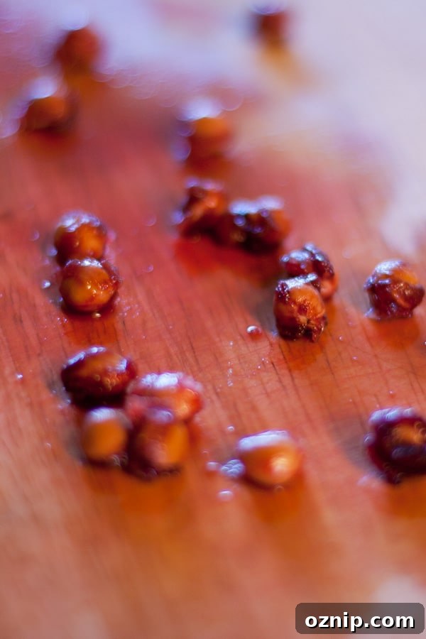 cherry pits on a wooden cutting board.