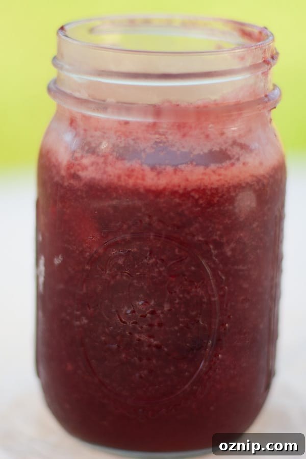 a glass mason jar filled with cherry plum jam.