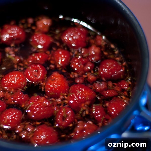 Raspberries and lime zest steeping in a pot.