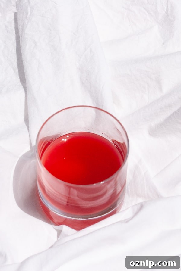 looking down on a glass of red syrup.