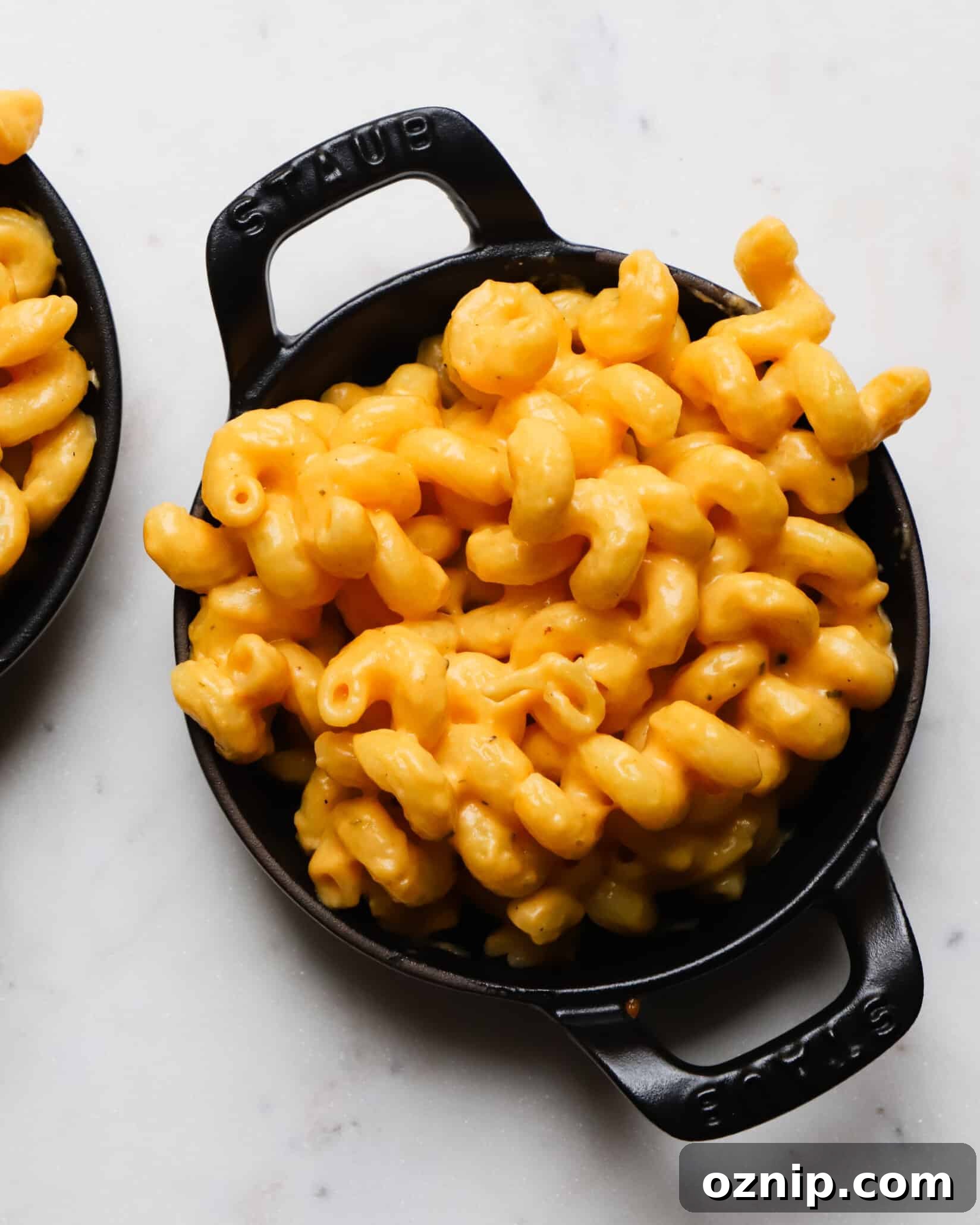 Creamy buffalo macaroni and cheese in a black cast iron dish.
