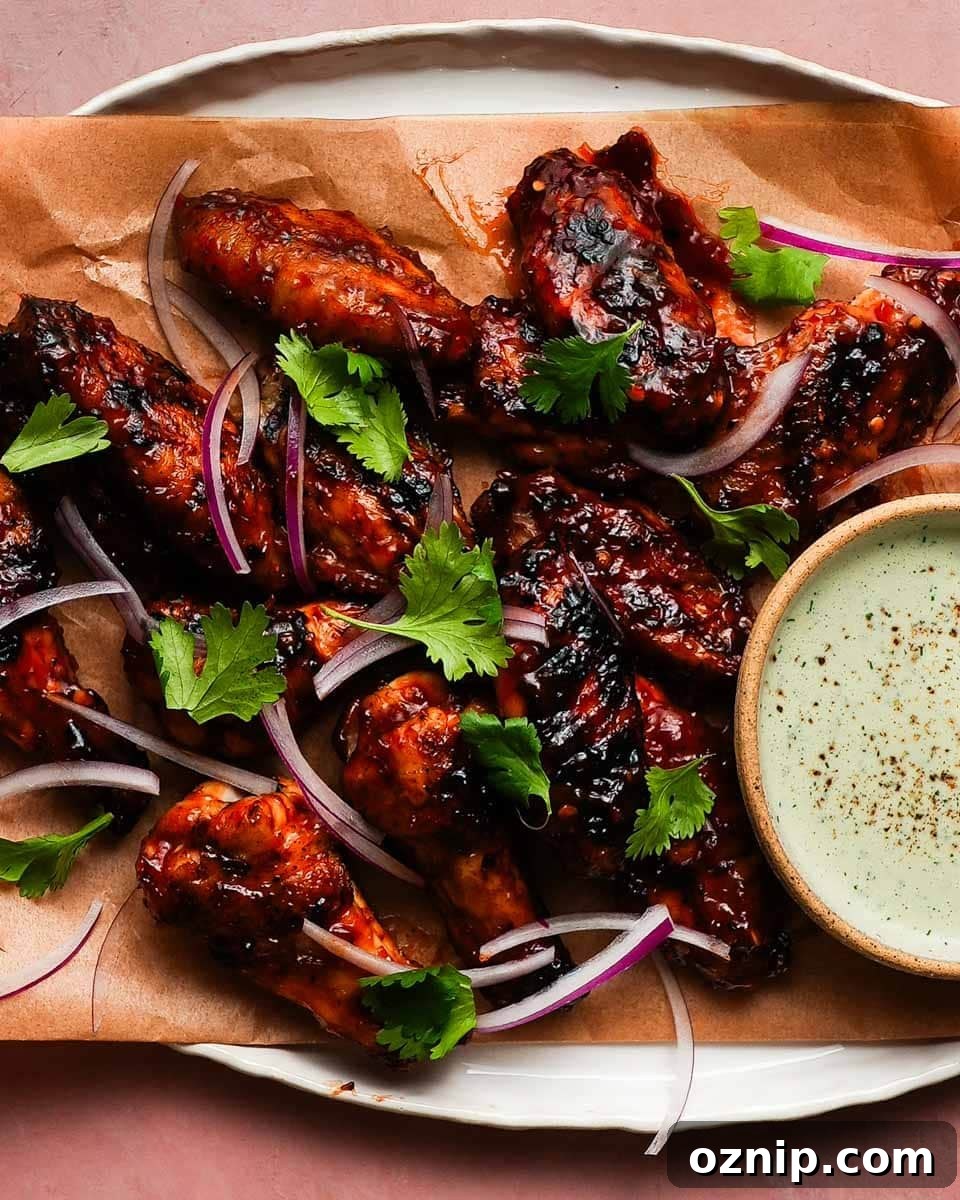 Grilled chicken wings with Sambal BBQ sauce, red onions, cilantro, and dipping sauce.