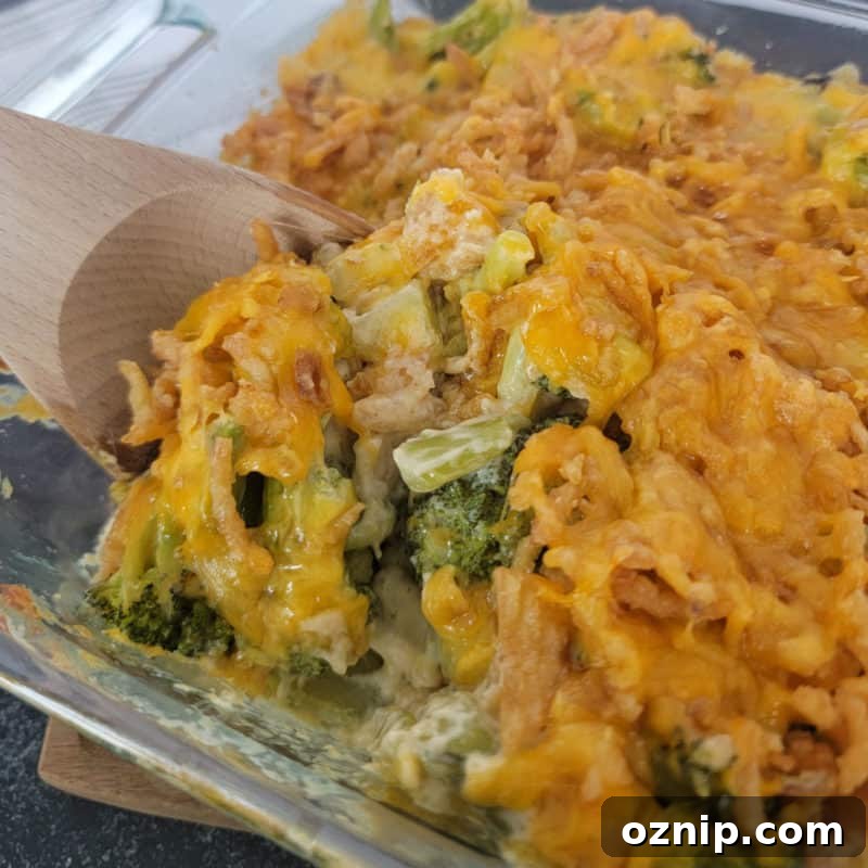 30+ Side Dishes for Soup to Complete Your Meal 11 Wooden spoon scooping Broccoli Casserole from a glass baking dish