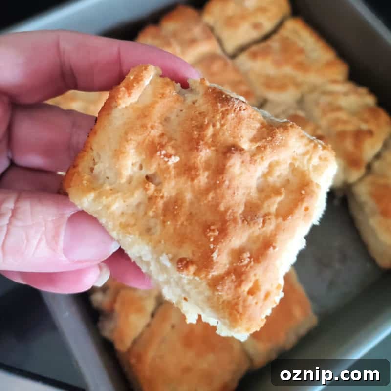 30+ Side Dishes for Soup to Complete Your Meal 13 7 Up biscuit being held above a pan of biscuits