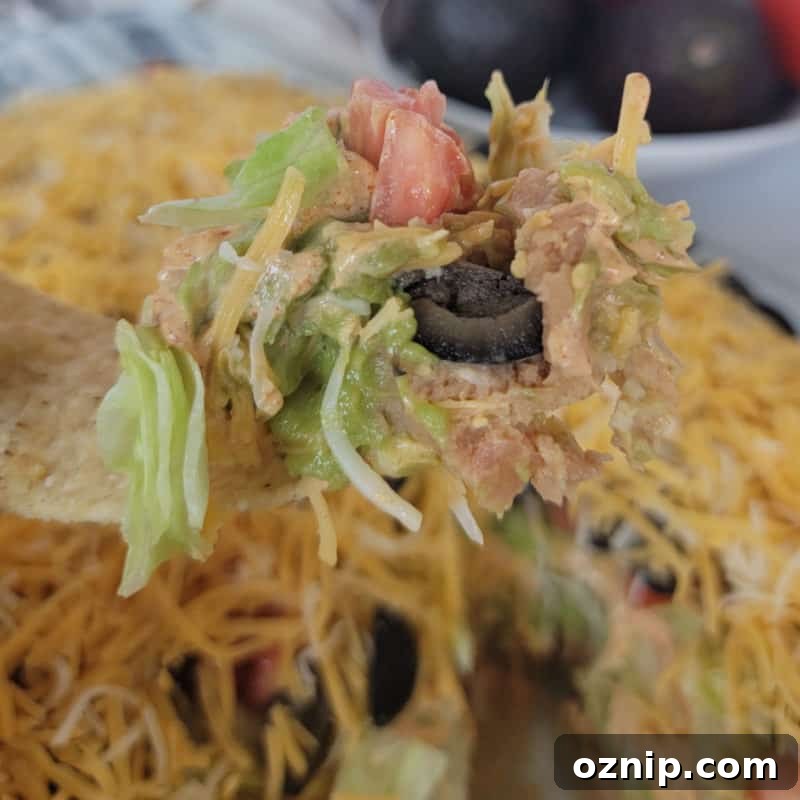 30+ Side Dishes for Soup to Complete Your Meal 23 Tortilla holding 7 layer taco dip above a full casserole dish