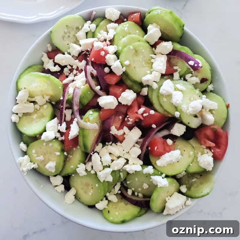 30+ Side Dishes for Soup to Complete Your Meal 31 Greek Cucumber Salad with Feta in a white bowl