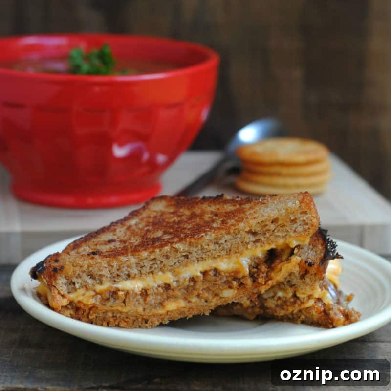 30+ Side Dishes for Soup to Complete Your Meal 7 sloppy joe grilled cheese on a white plate next to a bowl of tomato soup