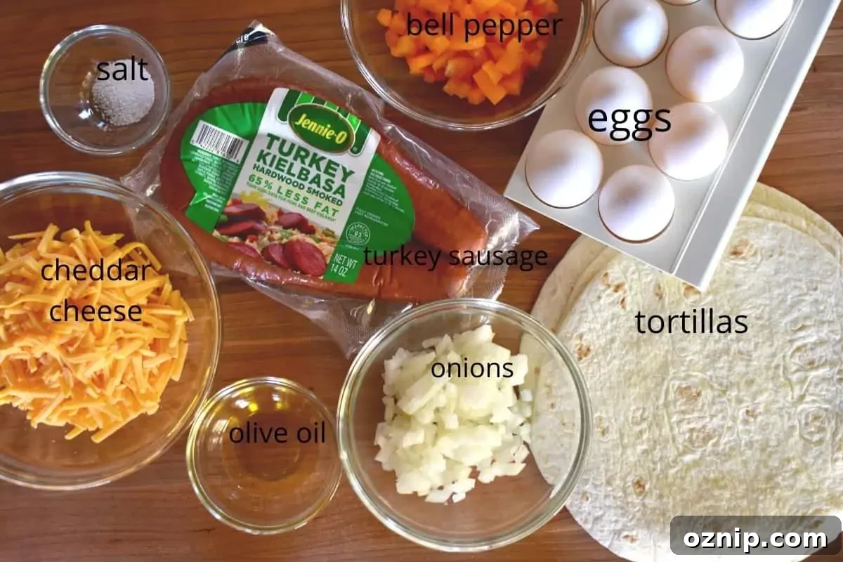 Freezer-Friendly Turkey Sausage Breakfast Burritos Recipe 3 Overhead photo of all of the ingredients needed for this recipe on a wood cutting board.