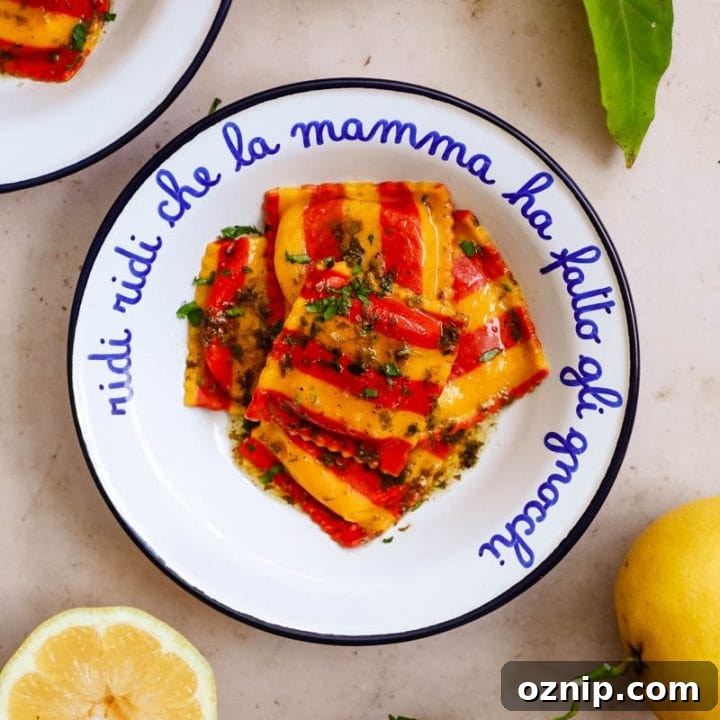 Lobster Ravioli in a lemon garlic butter sauce in a white and blue Italian enamel bowl with lemons.