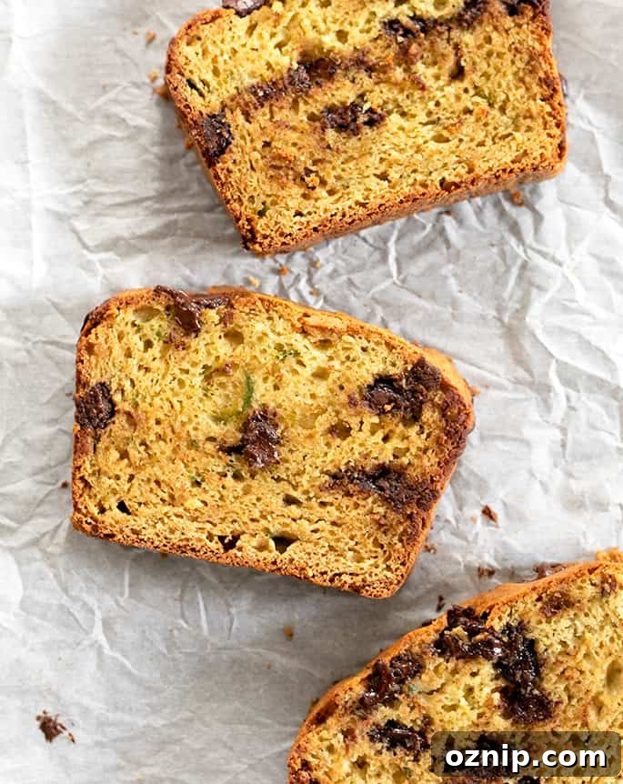 3 Slices of Gluten free zucchini bread laying on parchment.