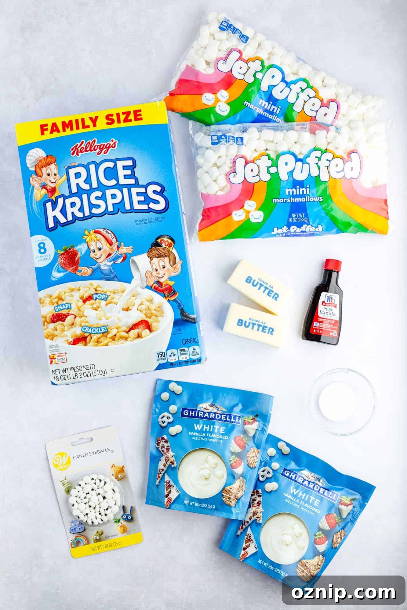 Overhead shot of ingredients needed to make rice krispie treats with white chocolate and candy eyes