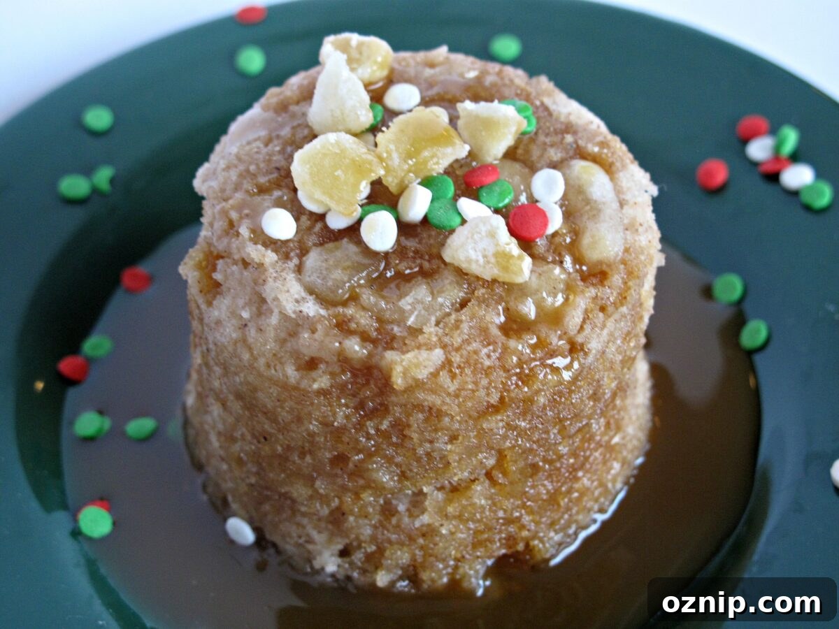 Gingerbread Mug Cake with Caramel Syrup Gingerbread Mug Cake with caramel syrup on a green plate surrounded by caramel syrup and red and green sprinkles.