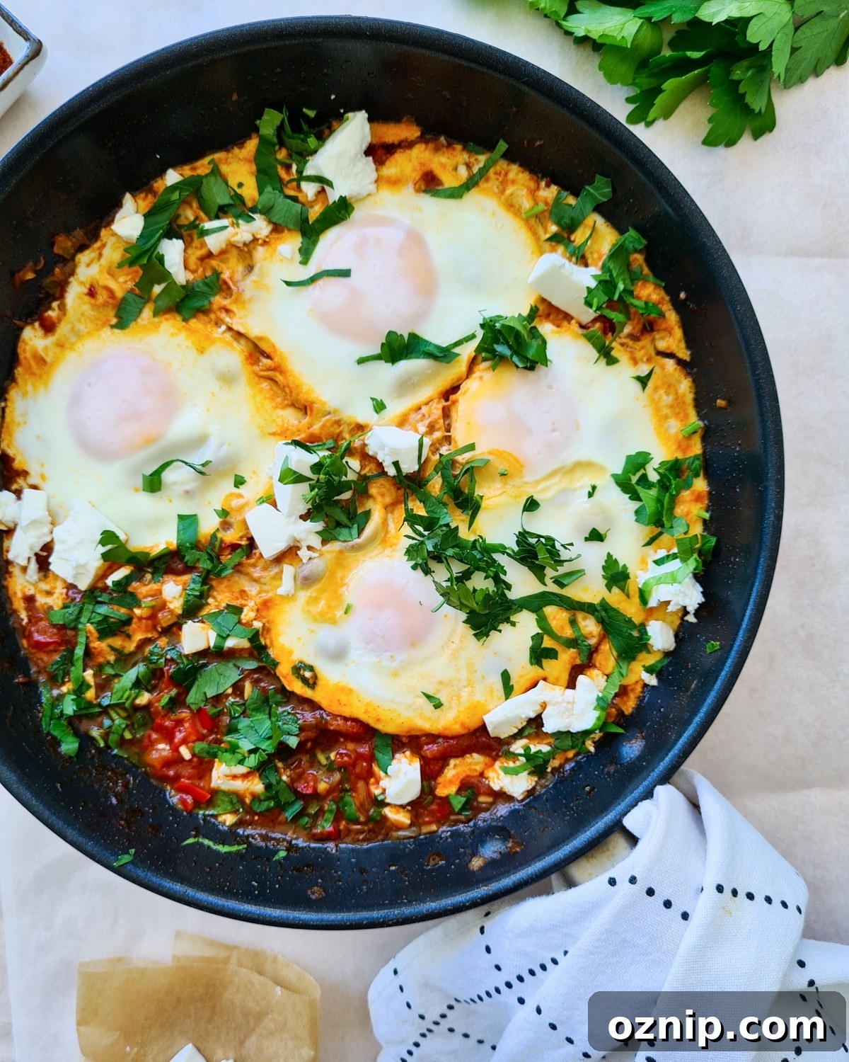 Feta Shakshuka Recipe with Poached Eggs 12 a pan full of shakshuka with feta