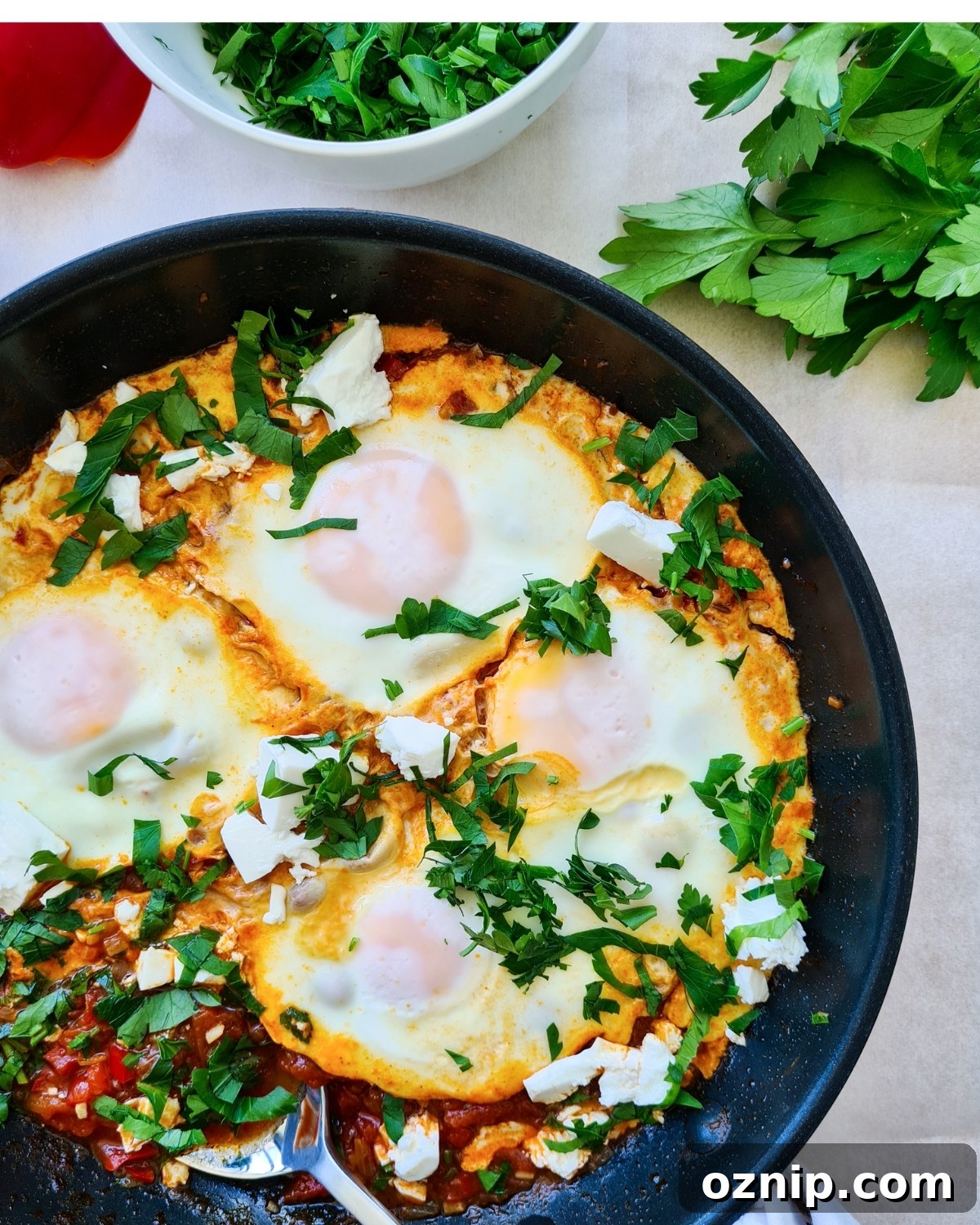 Feta Shakshuka Recipe with Poached Eggs 14 Pan of shakshuka with feta ready to serve