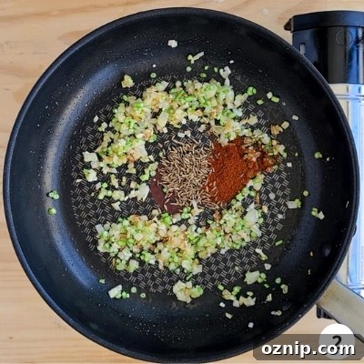 Feta Shakshuka Recipe with Poached Eggs 5 spices added into pan for low heat frying
