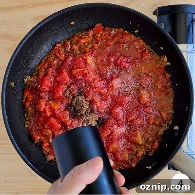 Feta Shakshuka Recipe with Poached Eggs 7 crushed tomatoes into the pan with other seasoning
