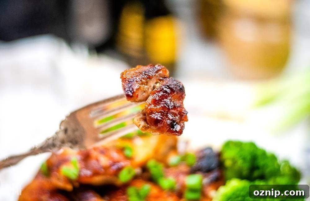 Air Fryer Huli Huli Chicken Recipe 7 Closeup view of a piece of air fryer Hawaiian chicken on a fork.