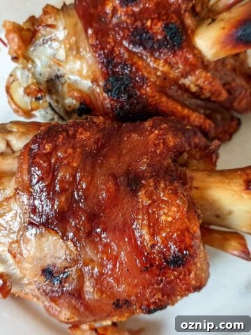2 crispy pork knuckles on a plate.