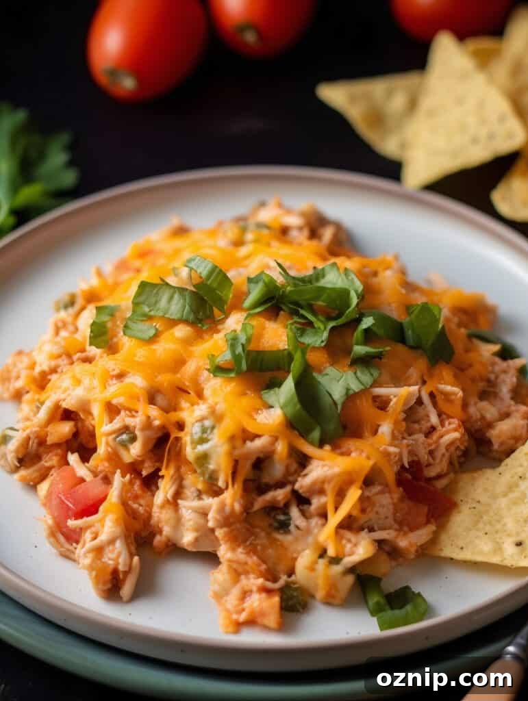 Cheesy Mexican Chicken Casserole with Tortillas 3 Layered Mexican chicken casserole in a baking dish