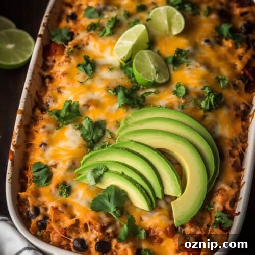 Cheesy Mexican Chicken Casserole with Tortillas 7 Cheesy Mexican chicken casserole with avocado and lime on top
