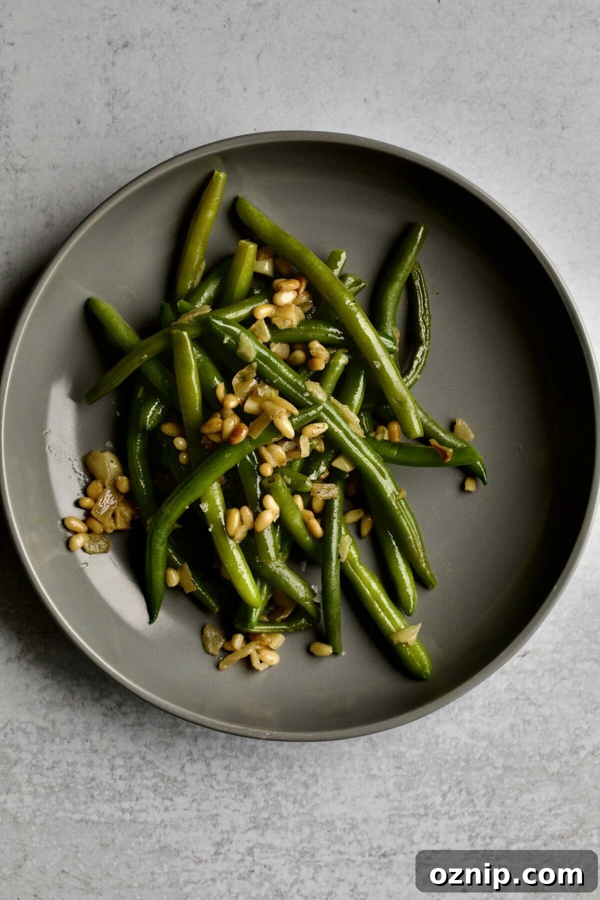 Sautéed Frozen Green Beans Recipe (Easy) on a grey plate.