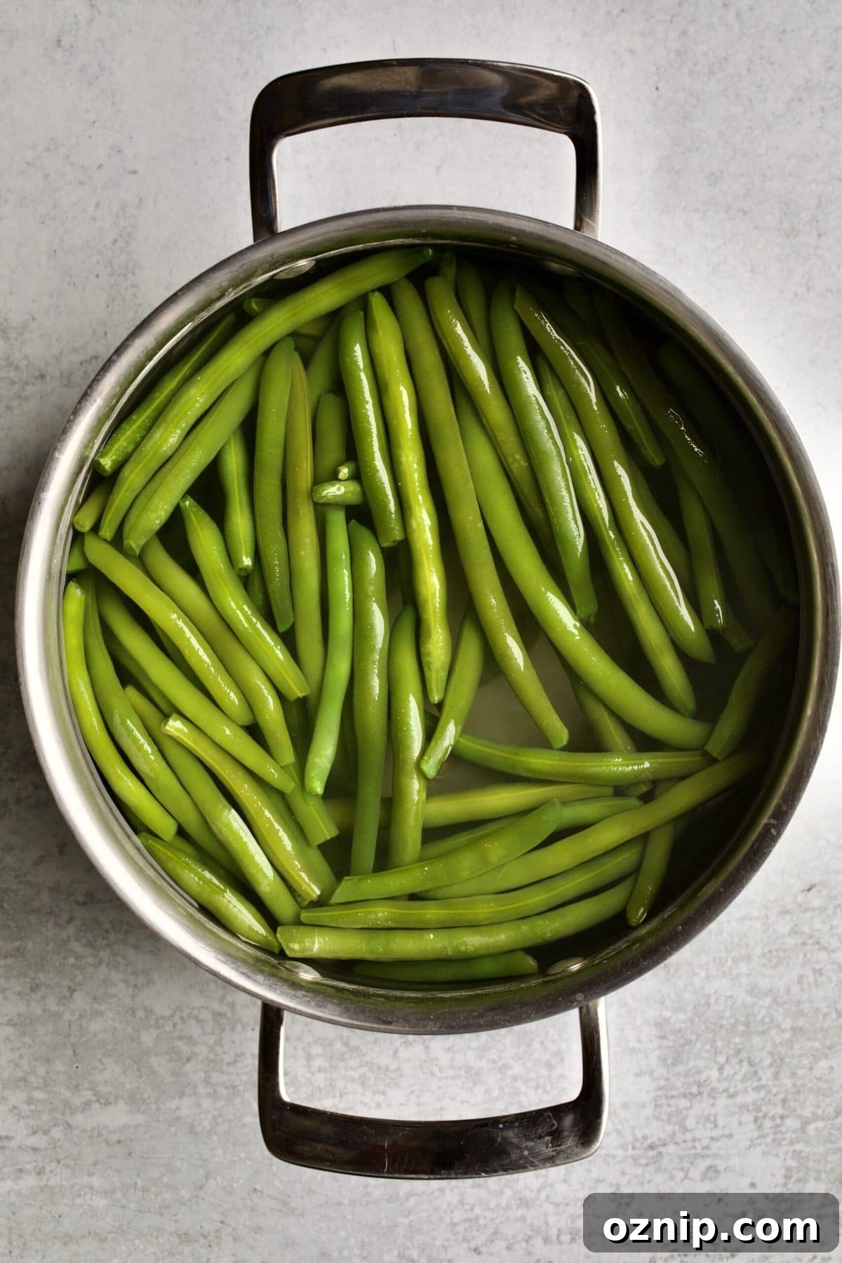 process of making sautéed green beans: boiling the green beans.