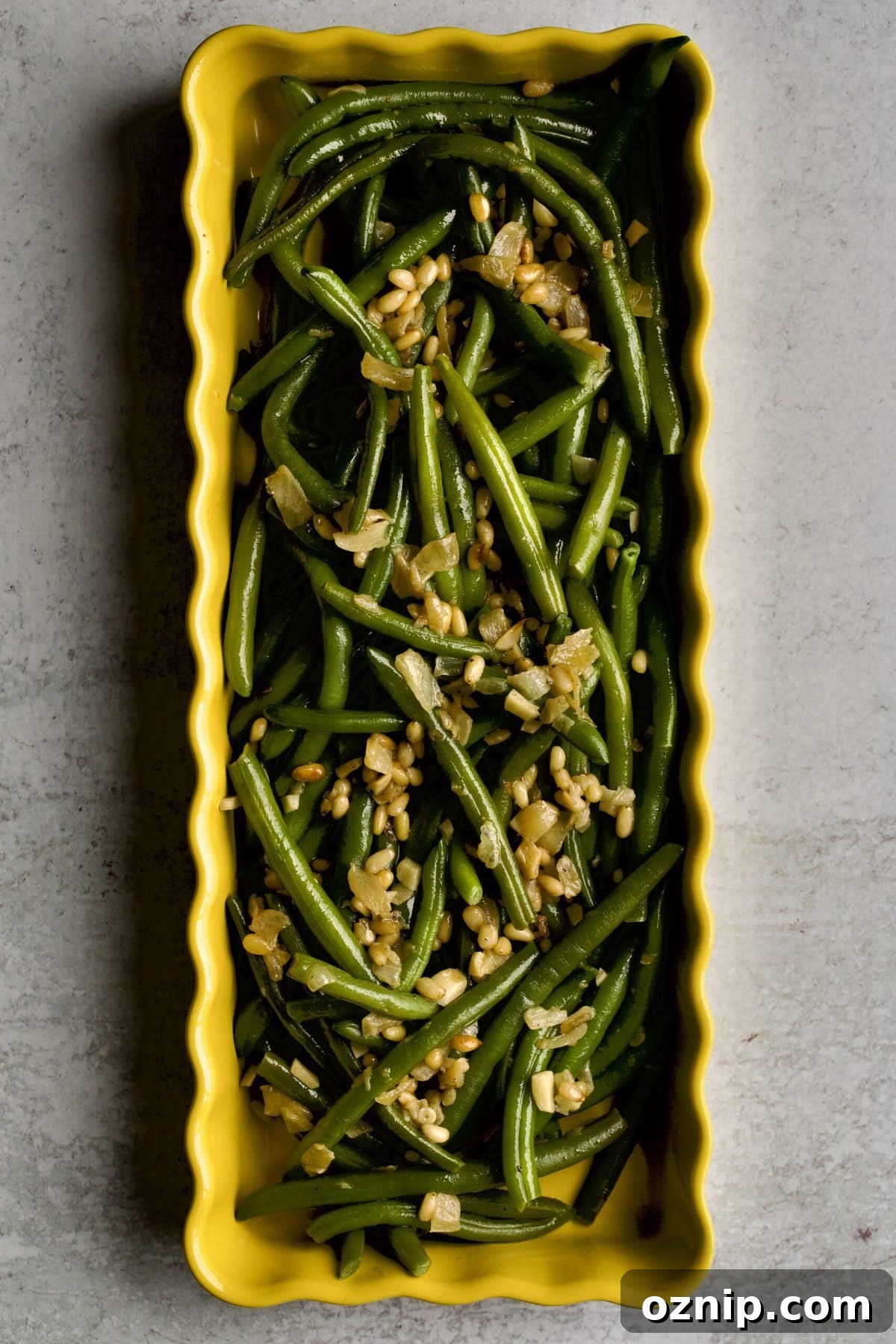 Sautéed Frozen Green Beans Recipe (Easy) on a yellow serving platter.