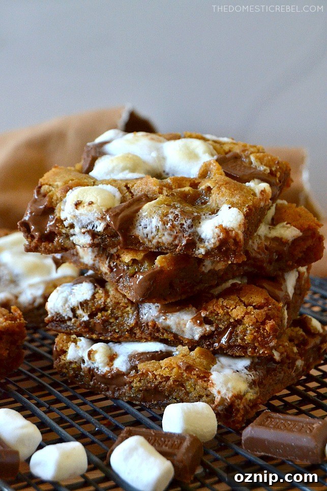 stack of s'mores cookie bars with marshmallows and hershey bars on wire rack