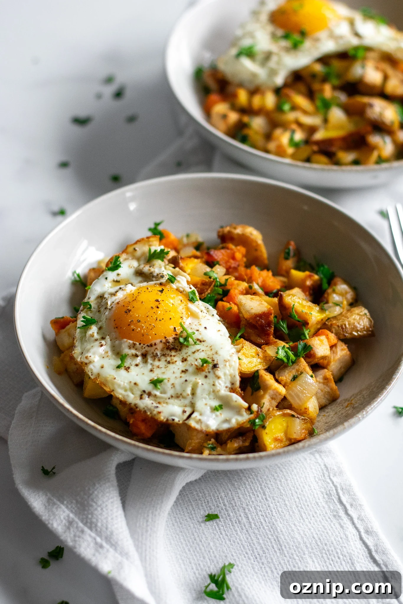 Biksemad: Traditional Danish Meat and Potato Hash Recipe 3 A bowl of veggies and meat topped with a fried egg.