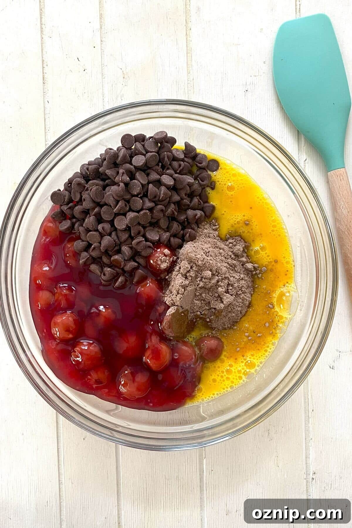 The cake ingredients of cake mix, cherry pie filling, eggs, chocolate chips.