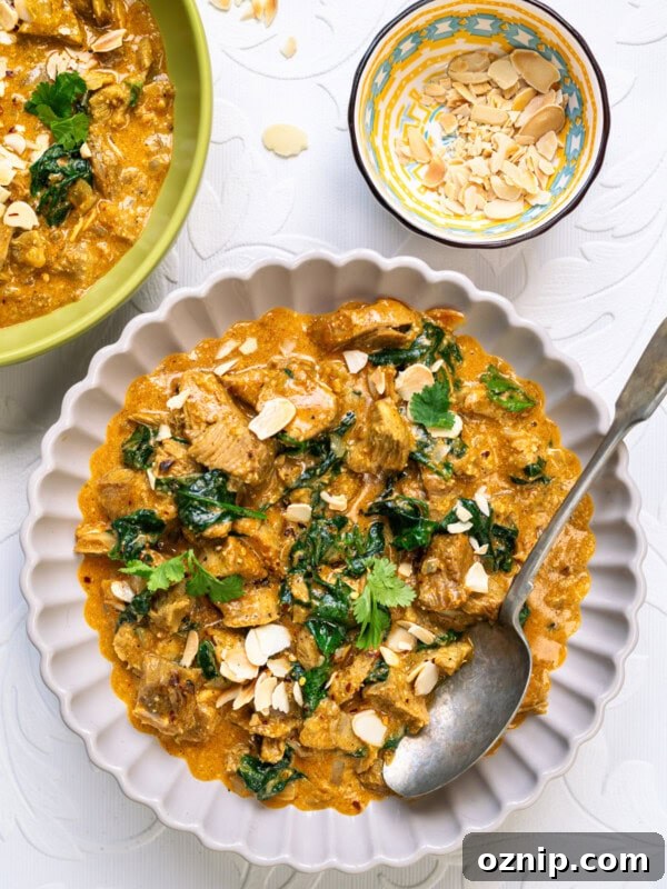 Leftover turkey curry in a bowl garnished with cilantro and almonds