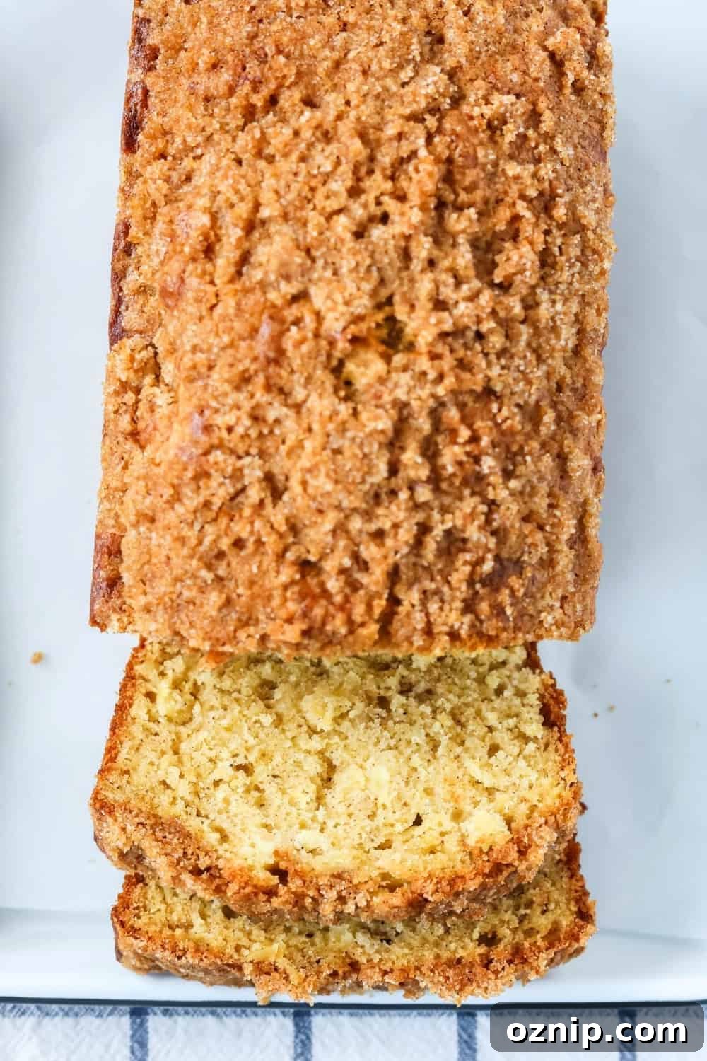 overhead view of a sliced loaf of pineapple quick bread topped with streusel topping