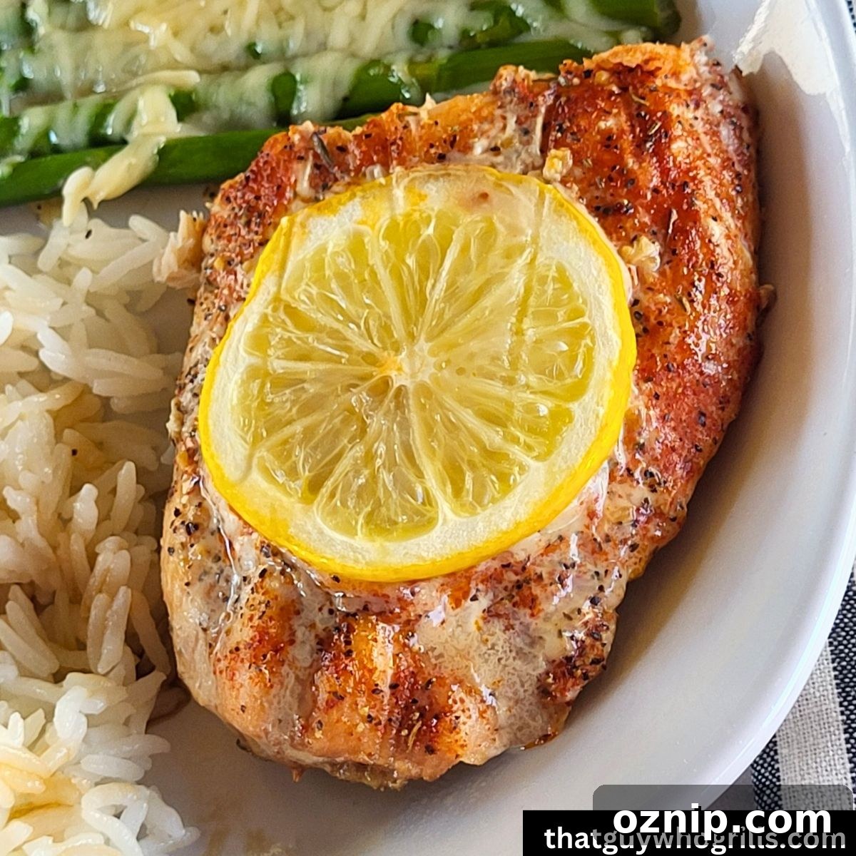 Grilled Salon with lemon slice white rice and cheesy asparagus