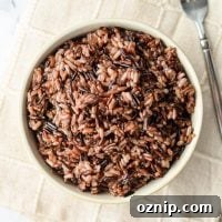An overhead shot of a bowl of wild rice blend, with a fork on the side.