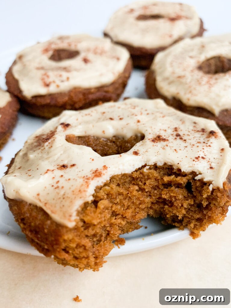 Fluffy Pumpkin Donuts with Cream Cheese Frosting 2 Pumpkin donuts on a plate with cream cheese frosting