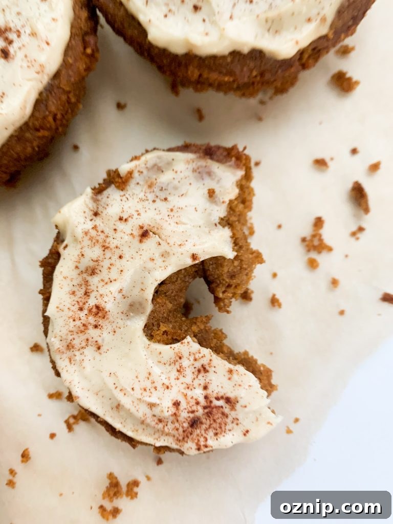 Fluffy Pumpkin Donuts with Cream Cheese Frosting 3 Close up of a pumpkin donut with frosting