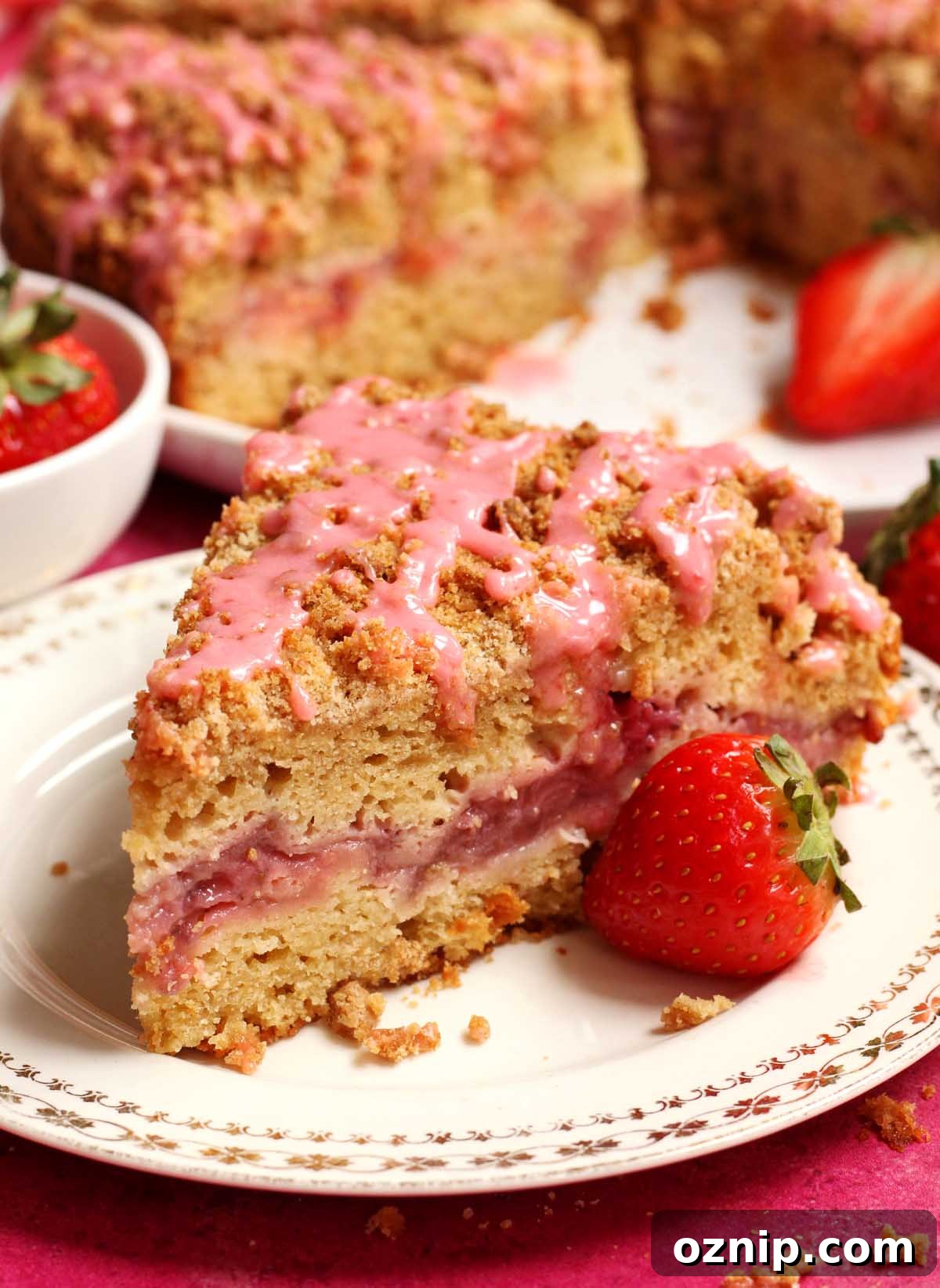maple strawberry coffee cake sliced on a plate with strawberry