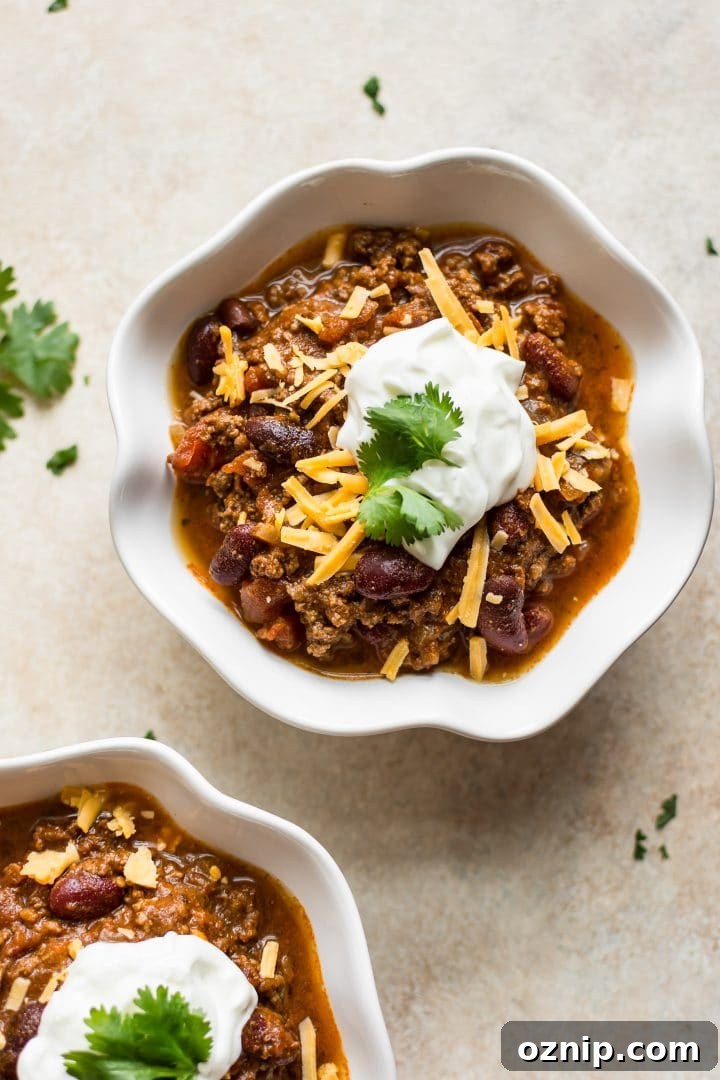 white bowl with healthy and delicious Instant Pot chili recipe with beef, beans, tomatoes, and a spice blend