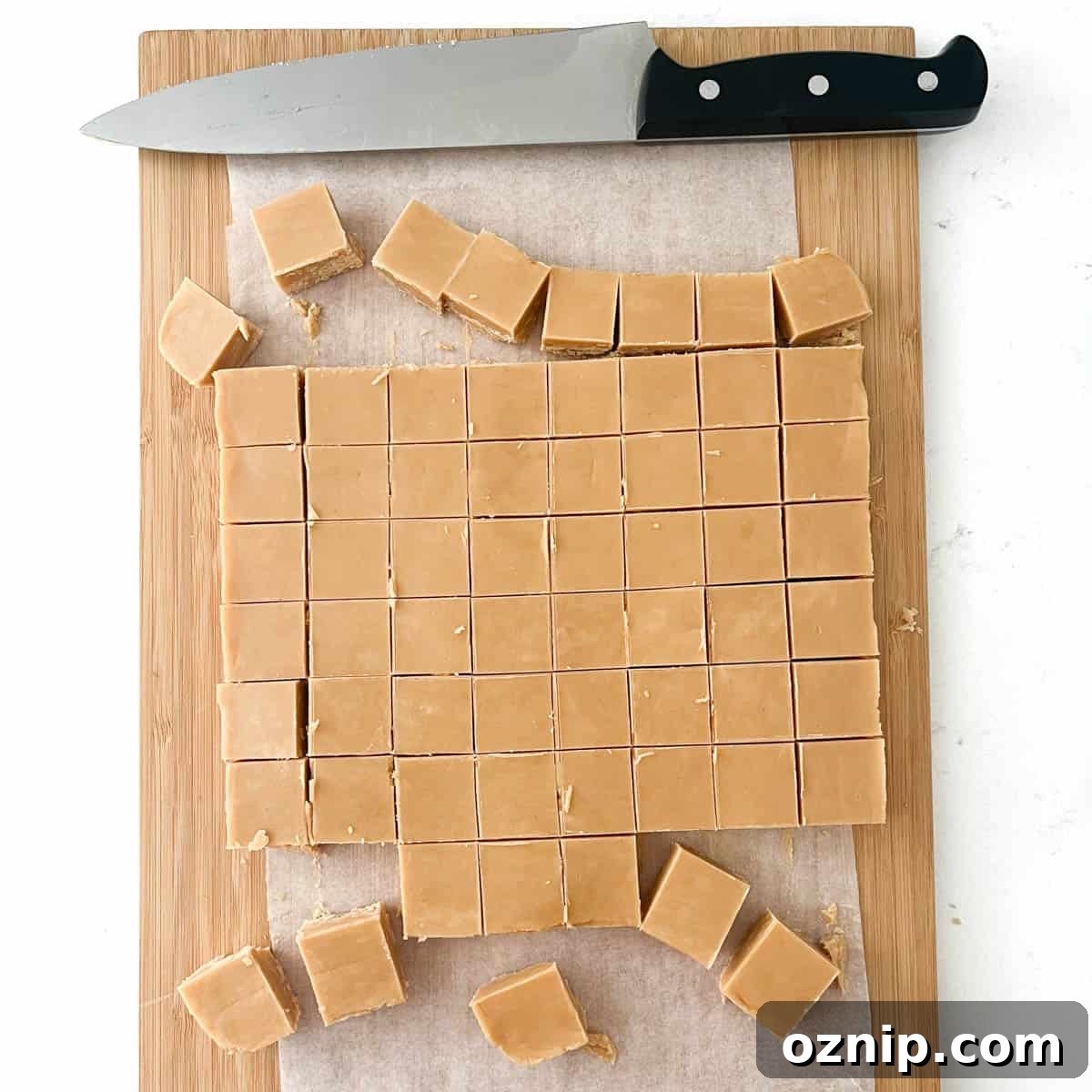 Peanut butter fudge in a chopping board, slice into small slices.