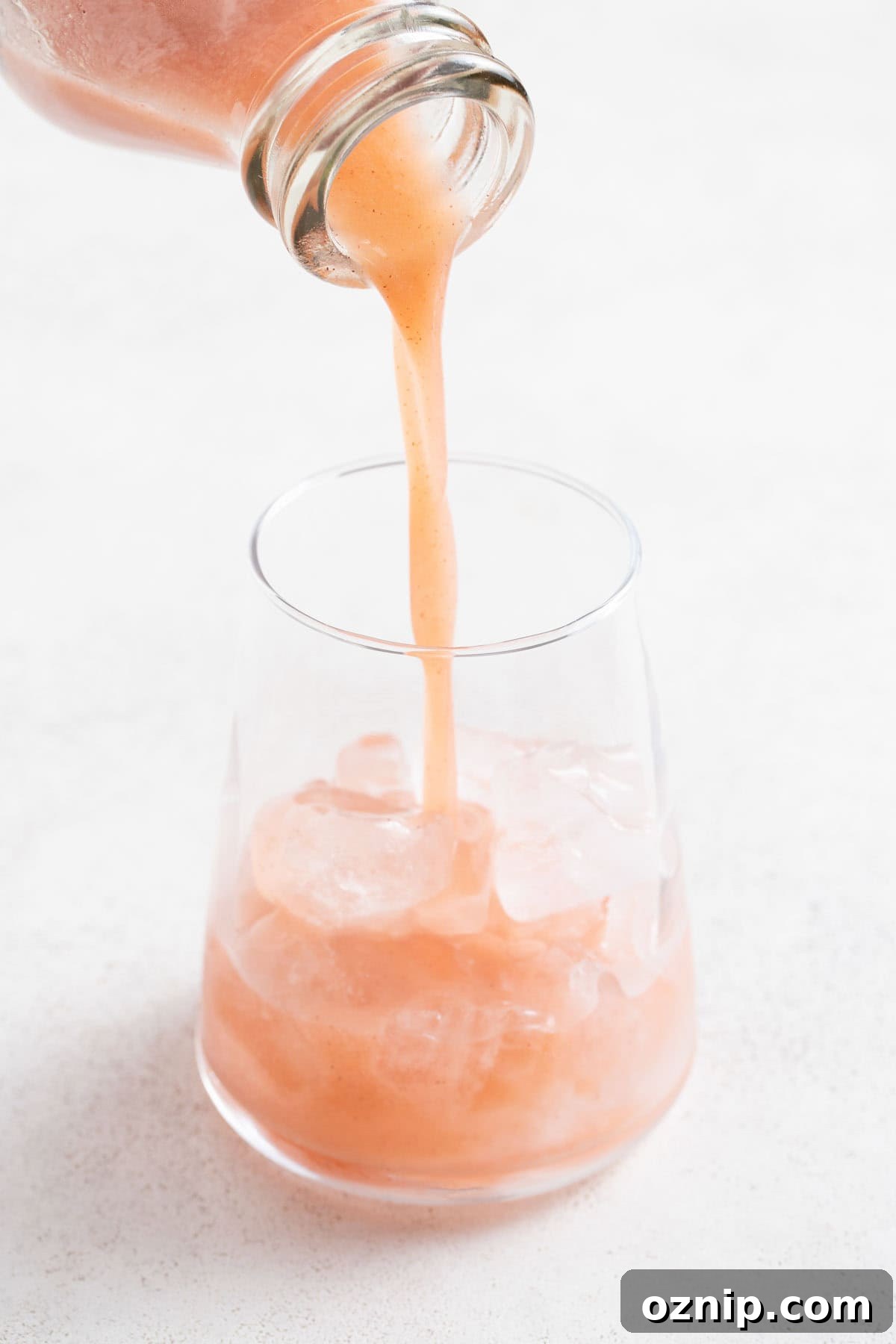 Strawberry Cocktail to Reduce Cortisol, No Orange Juice 7 Pouring the kiwi strawberry juice into a glass with ice.