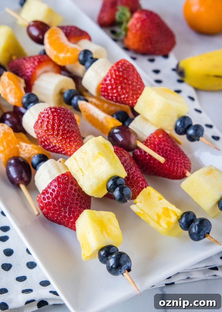 fruit skewers on a white plate