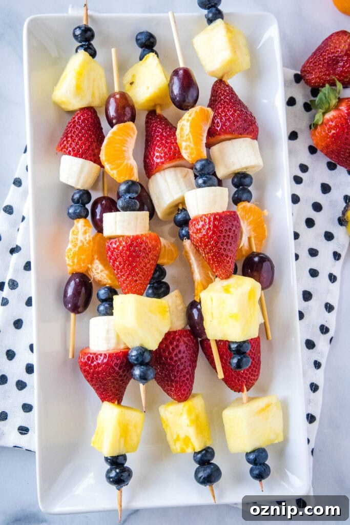 fruit skewers on a white platter