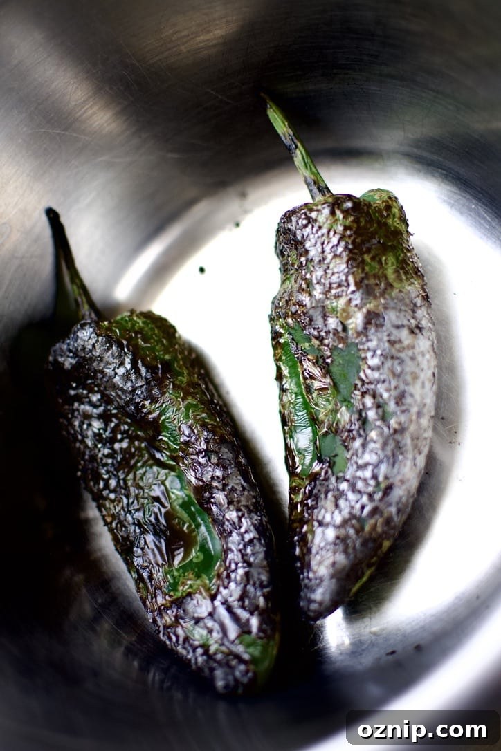 Blistered Poblano peppers in a bowl.