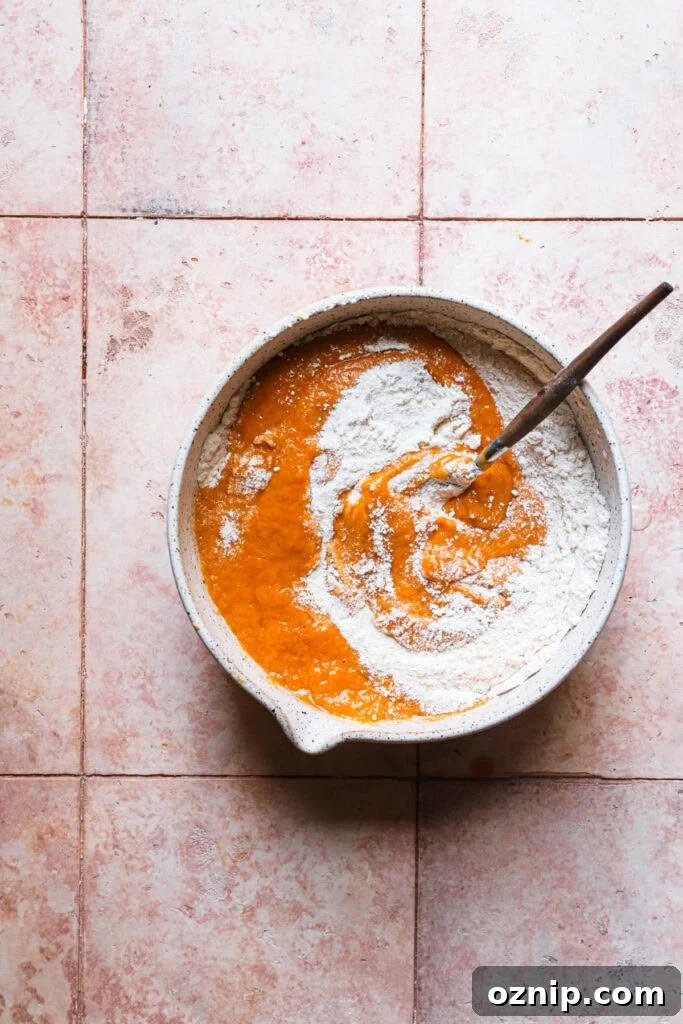 Moist Baked Pumpkin Donuts: Soft Fall Donut Recipe 6 A bowl with pumpkin donuts mixture.