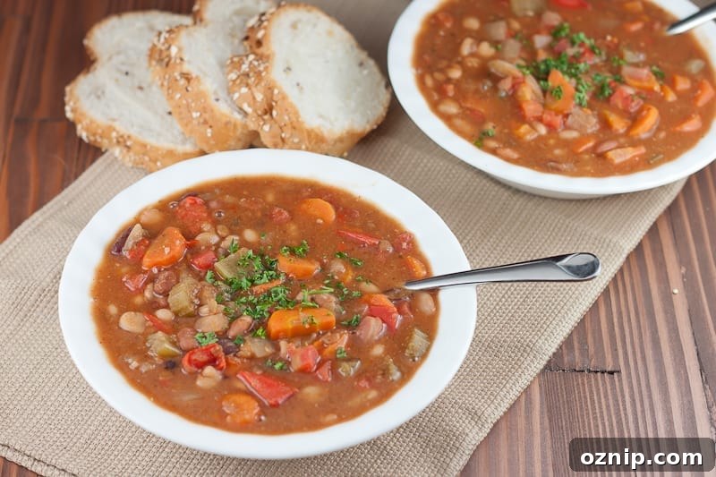 Instant Pot 15 Bean soup recipe in a white bowl served with sliced bread