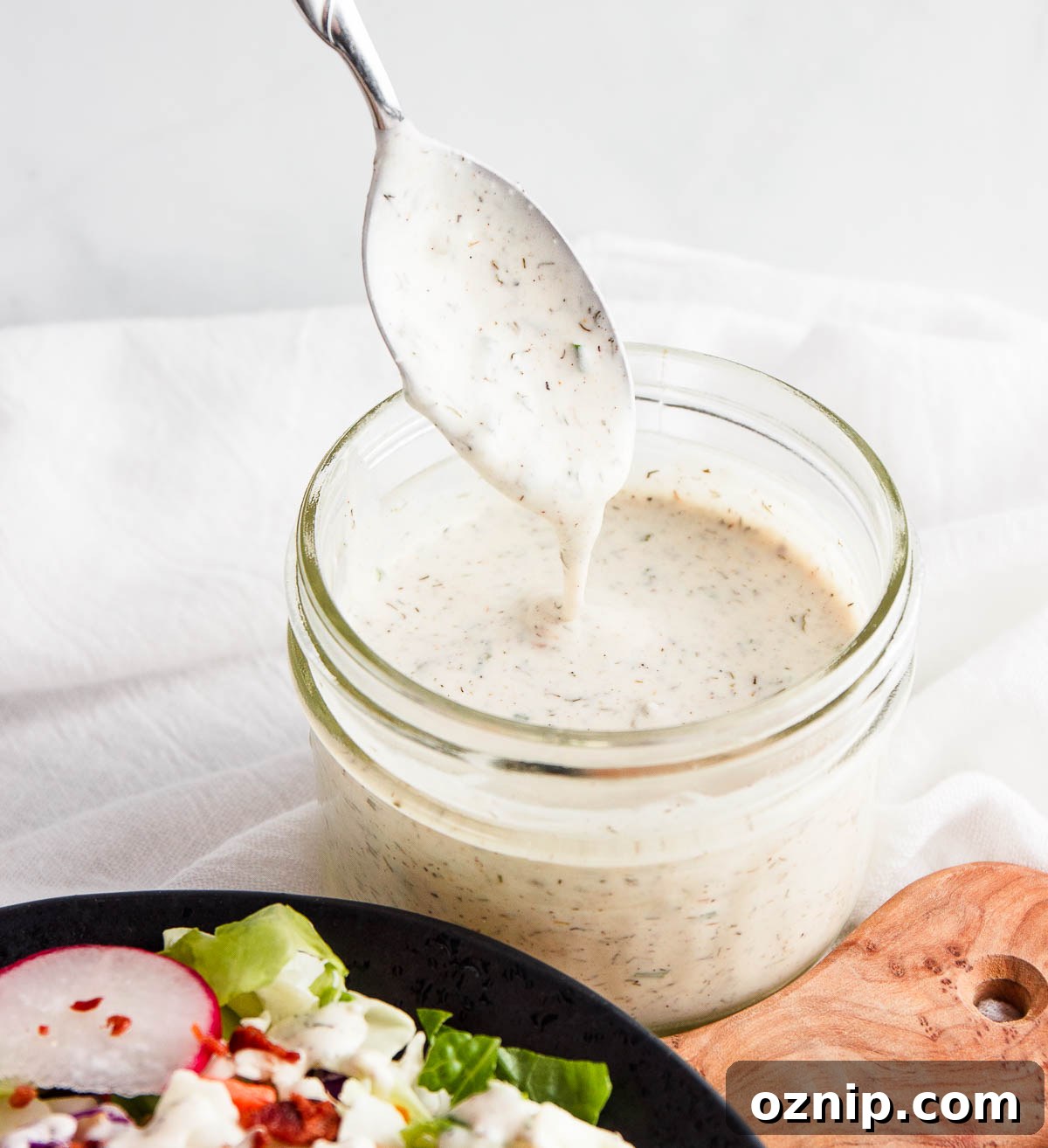 Pouring ranch dressing into a sealed jar.