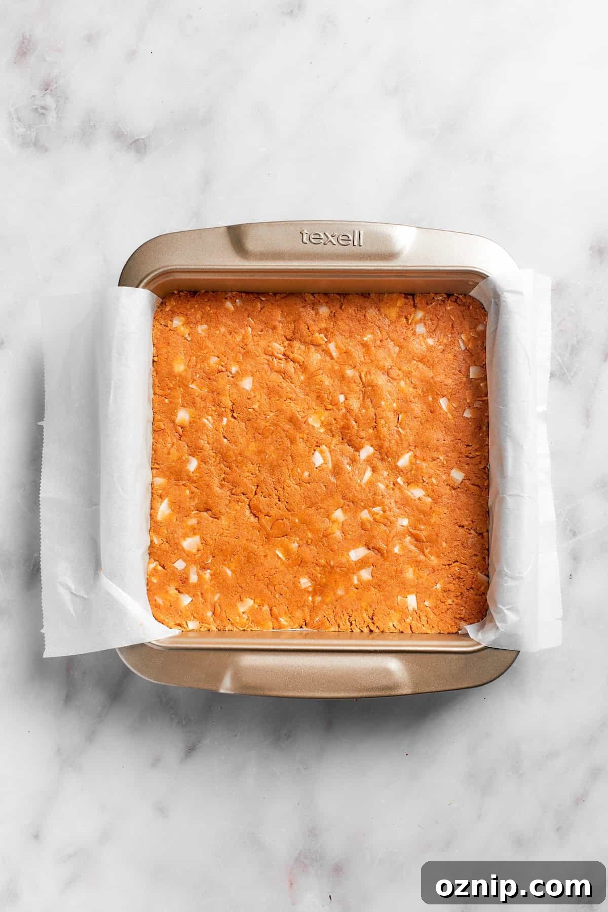 Graham cracker crust is pressed in a pan.
